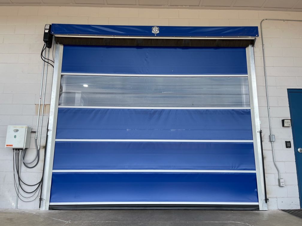 A blue high speed door with a clear panel for visibility