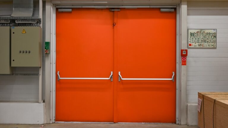 orange commercial fire doors sitting closed in a building
